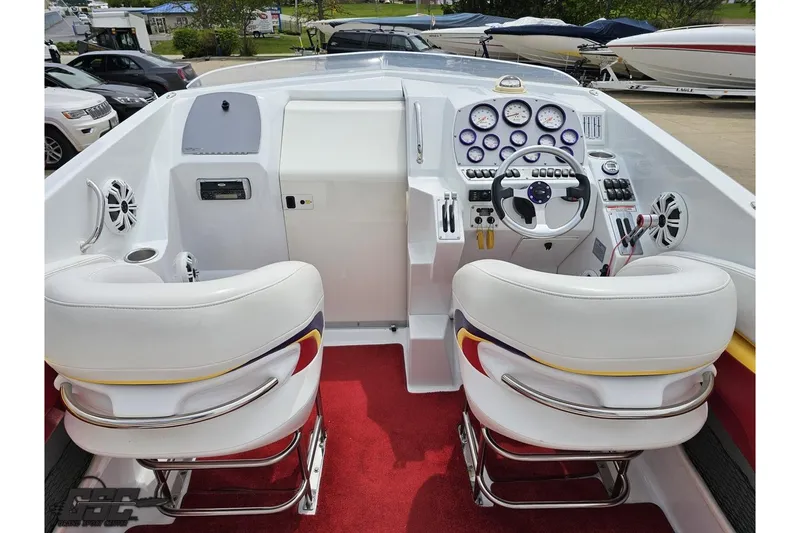 Slide: The Image of 2005 Baja 30 Outlaw boat cockpit with white seats and red carpet. - 46
