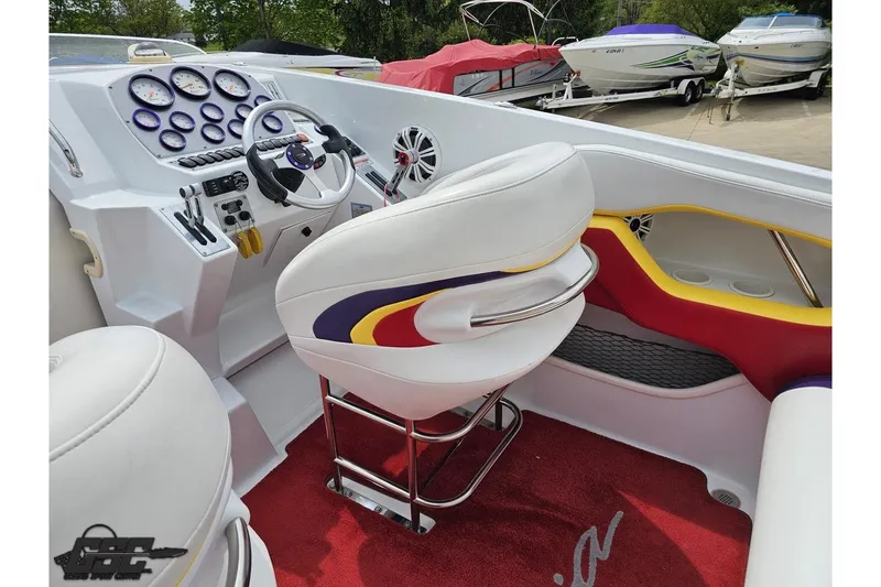 Slide: The Image of 2005 Baja 30 Outlaw boat interior with white seats and colorful accents. - 49