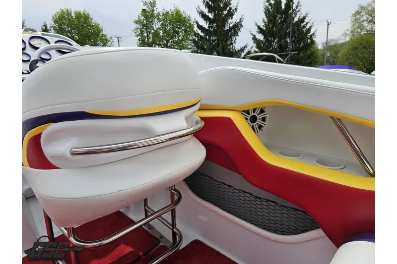 Slide: The Image of Interior of 2005 Baja 30 Outlaw boat with colorful seating and speaker system. - 50