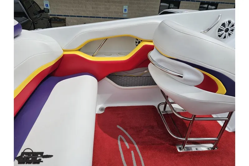 Slide: The Image of 2005 Baja 30 Outlaw boat interior with colorful seating and red carpet. - 51