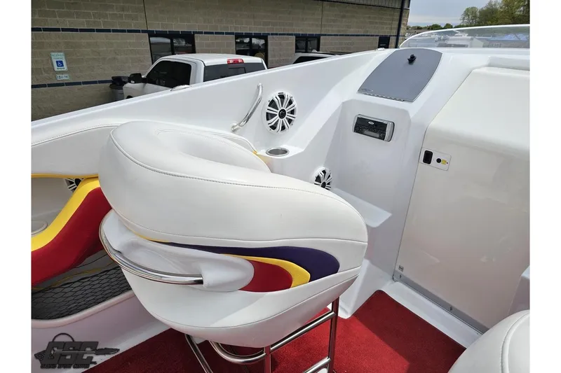 Slide: The Image of Interior of a 2005 Baja 30 Outlaw boat with white seating and audio system. - 53