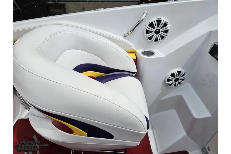 Slide: The Image of White and colorful seat in 2005 Baja 30 Outlaw boat interior with speakers. - 54