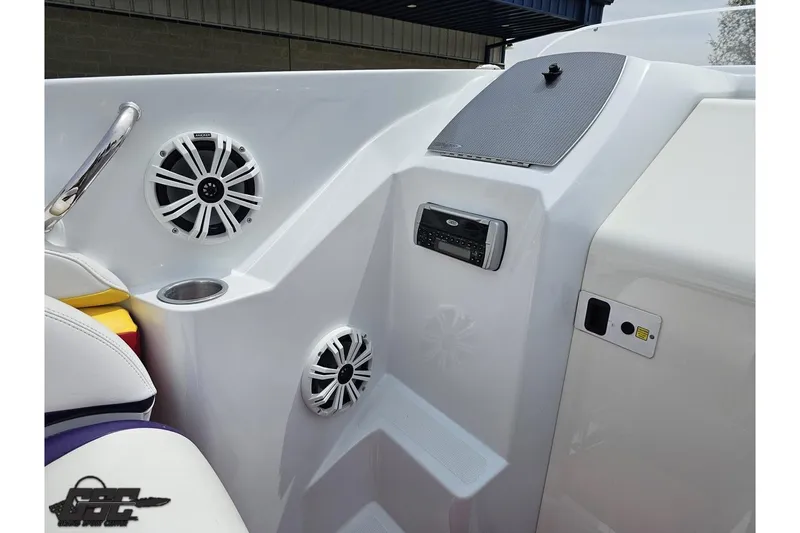 Slide: The Image of Interior of a 2005 Baja 30 Outlaw boat featuring speakers and control panel. - 56
