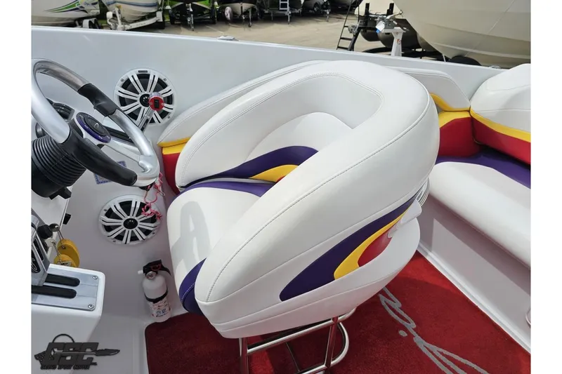Slide: The Image of 2005 Baja 30 Outlaw boat interior with colorful seating and steering wheel. - 57