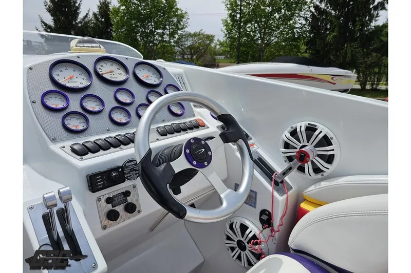 Slide: The Image of Cockpit of 2005 Baja 30 Outlaw boat with gauges and steering wheel. - 58