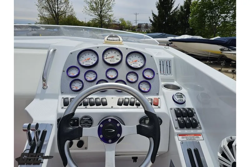 Slide: The Image of Cockpit view of a 2005 Baja 30 Outlaw boat with gauges and controls. - 59