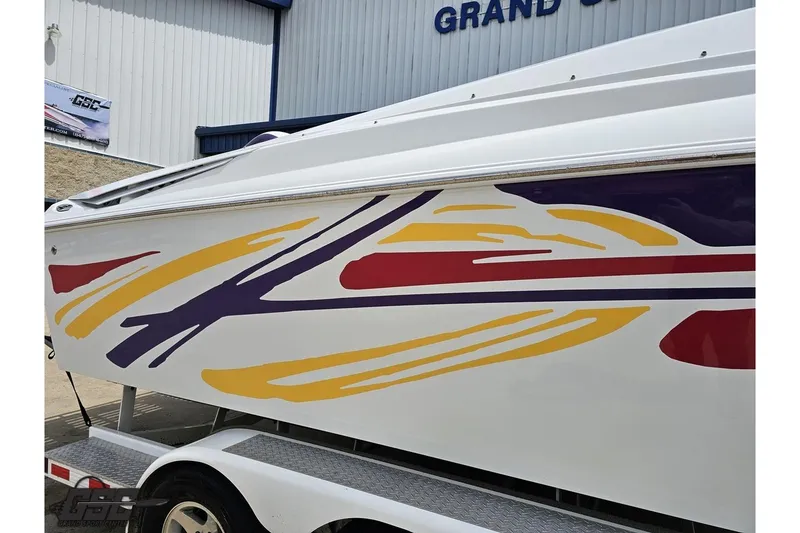 Slide: The Image of 2005 Baja 30 Outlaw boat with colorful graphics on trailer. - 6