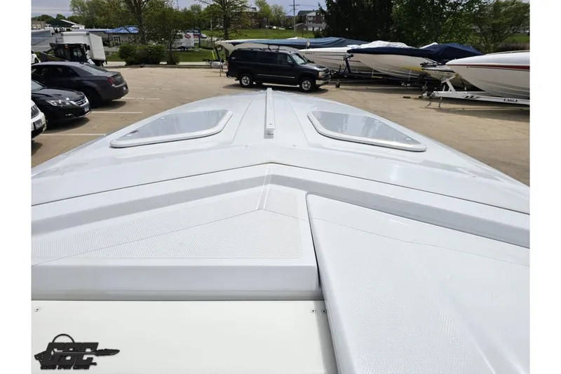 Slide: The Image of 2005 Baja 30 Outlaw boat deck view in a marina setting. - 61