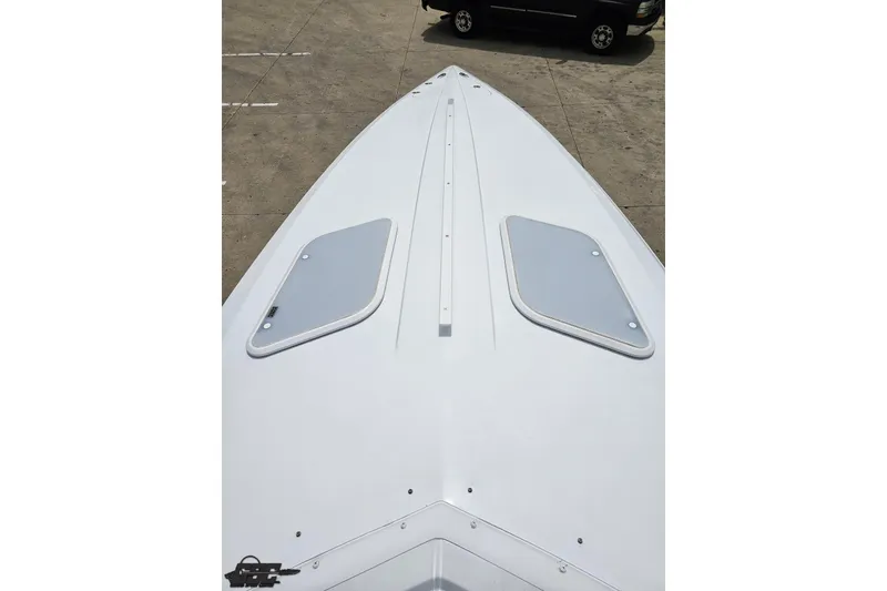 Slide: The Image of 2005 Baja 30 Outlaw boat deck, featuring sleek design and dual hatches. - 63