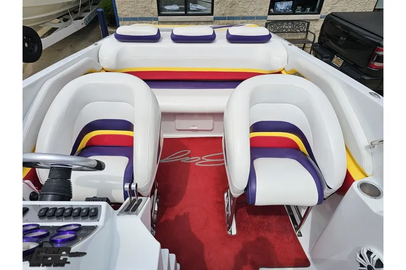 Slide: The Image of 2005 Baja 30 Outlaw boat interior with colorful seating and red carpet. - 64