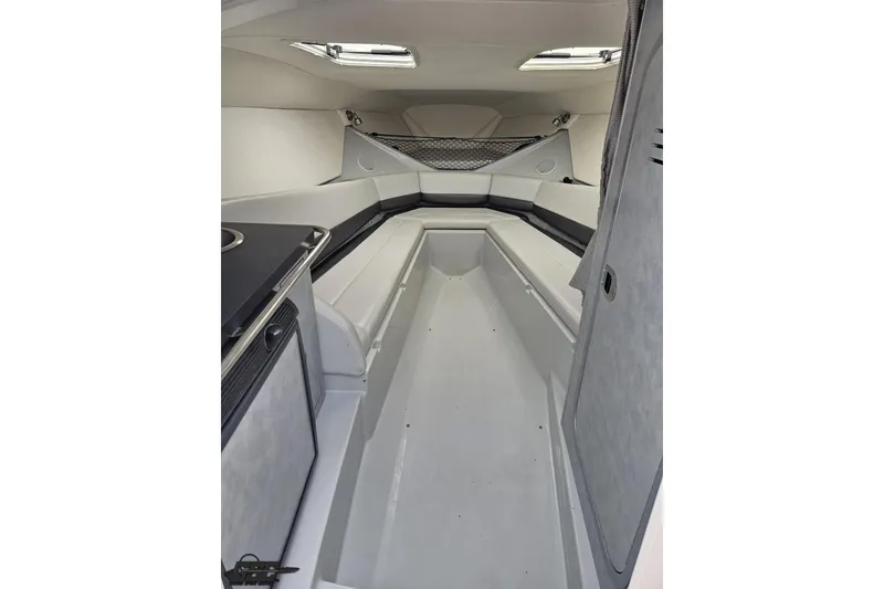 Slide: The Image of Interior cabin of a 2005 Baja 30 Outlaw boat, featuring sleek seating and modern design. - 66