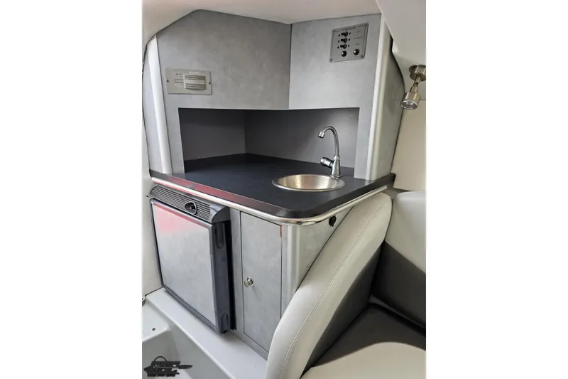 Slide: The Image of 2005 Baja 30 Outlaw boat interior with compact kitchenette and sink. - 69
