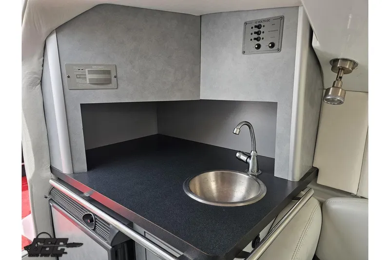 Slide: The Image of 2005 Baja 30 Outlaw boat interior with sink and control panel. - 70