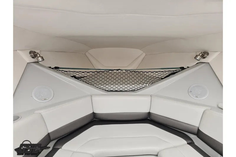 Slide: The Image of Interior of a 2005 Baja 30 Outlaw boat with white seating and storage net. - 72