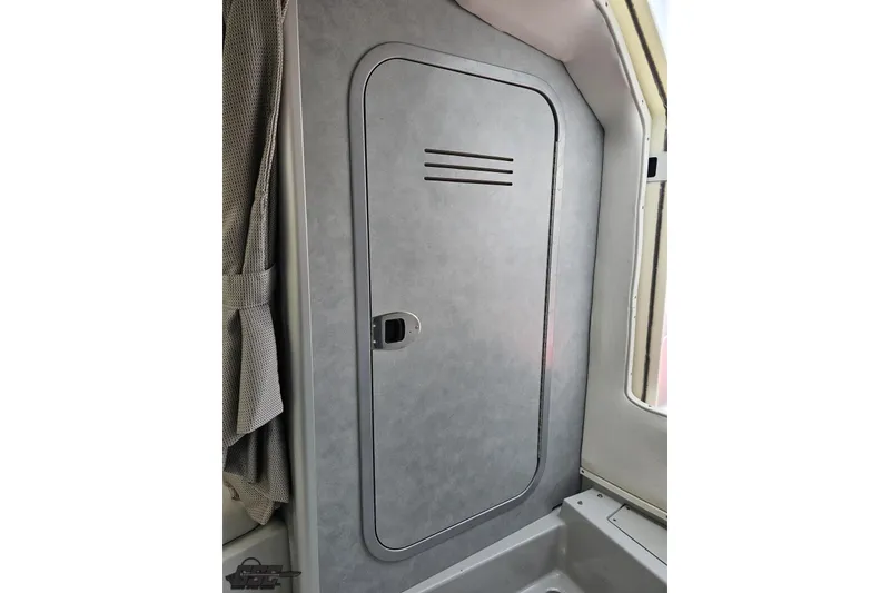Slide: The Image of Interior cabin door of a 2005 Baja 30 Outlaw boat. - 74