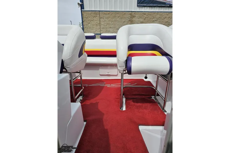 Slide: The Image of 2005 Baja 30 Outlaw boat interior with colorful seating and red carpet. - 78