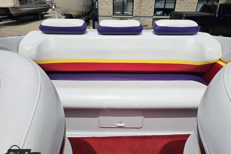 Slide: The Image of 2005 Baja 30 Outlaw boat interior with colorful seating and red carpet. - 82