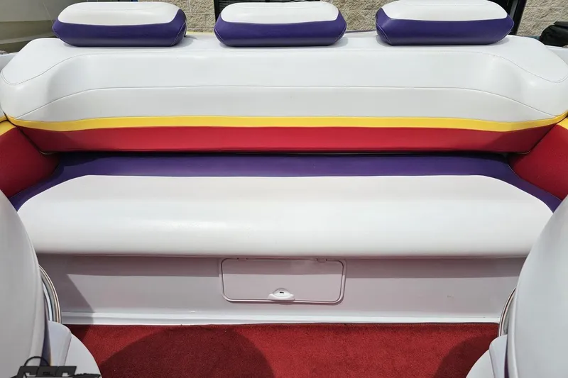 Slide: The Image of 2005 Baja 30 Outlaw boat interior with colorful seating and red carpet. - 83