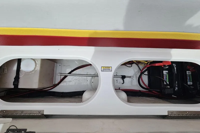 Slide: The Image of 2005 Baja 30 Outlaw boat interior showing battery compartment and wiring. - 85