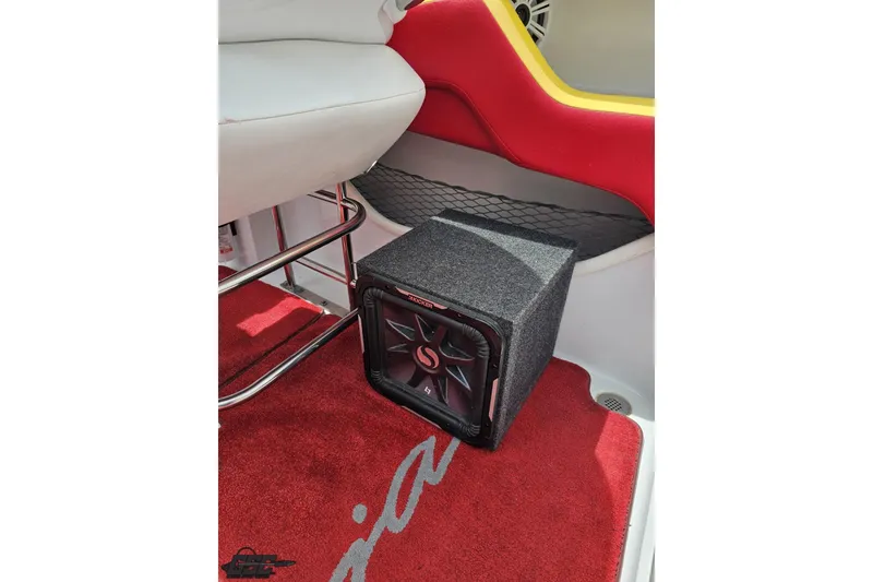 Slide: The Image of 2005 Baja 30 Outlaw boat interior with subwoofer on red carpet. - 91
