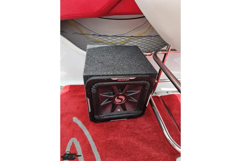 Slide: The Image of Kicker subwoofer on red carpet in 2005 Baja 30 Outlaw boat interior. - 92