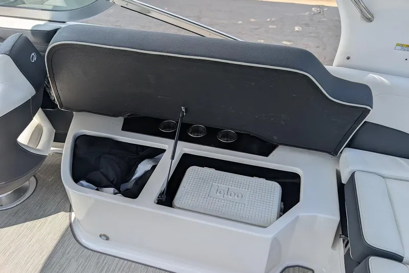 Slide: The Image of 2017 Regal 2500 Bowrider boat storage compartment with cooler and cup holders. - 13