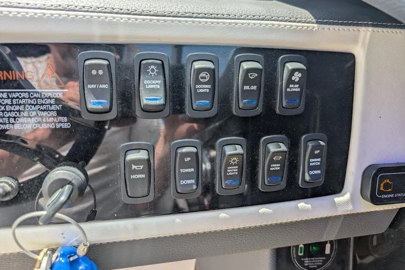 Slide: The Image of Control panel of a 2017 Regal 2500 Bowrider boat with various switches. - 18