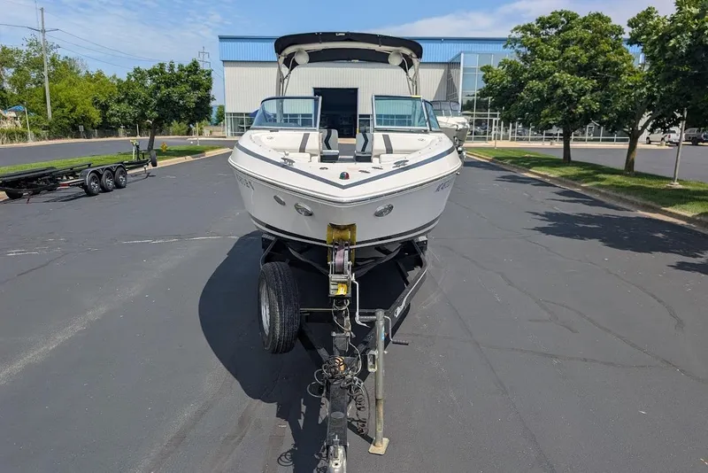 Slide: The Image of 2017 Regal 2500 Bowrider boat on trailer in parking lot. - 2
