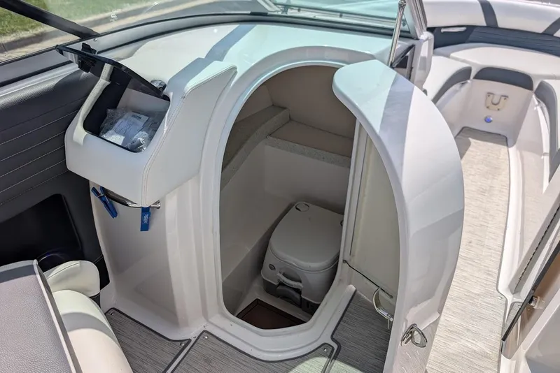 Slide: The Image of 2017 Regal 2500 Bowrider boat interior with open compartment and portable toilet. - 23