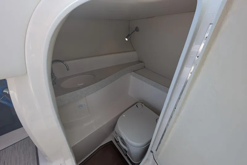 Slide: The Image of Compact bathroom in 2017 Regal 2500 Bowrider boat with sink and toilet. - 24
