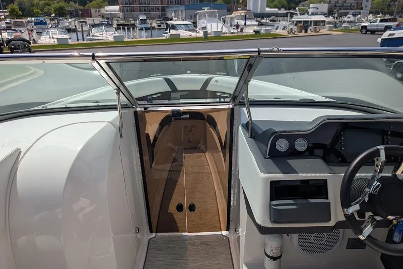 Slide: The Image of 2017 Regal 2500 Bowrider dashboard and cockpit view at marina. - 25