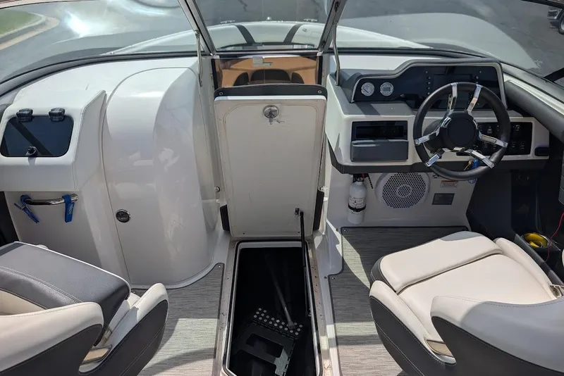 Slide: The Image of Interior of a 2017 Regal 2500 Bowrider boat, featuring steering wheel and seating. - 26