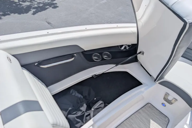 Slide: The Image of 2017 Regal 2500 Bowrider interior storage compartment with open seat and sleek design. - 31