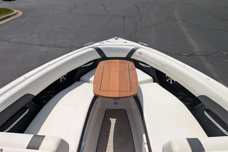 Slide: The Image of 2017 Regal 2500 Bowrider boat interior with wooden table and white seating. - 34