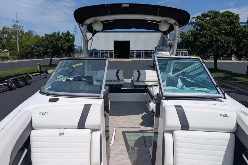 Slide: The Image of 2017 Regal 2500 Bowrider boat with open seating and sleek design, parked outdoors. - 35