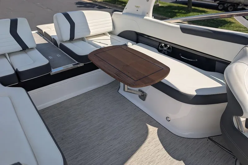 Slide: The Image of 2017 Regal 2500 Bowrider interior with white seating and wooden table. - 38