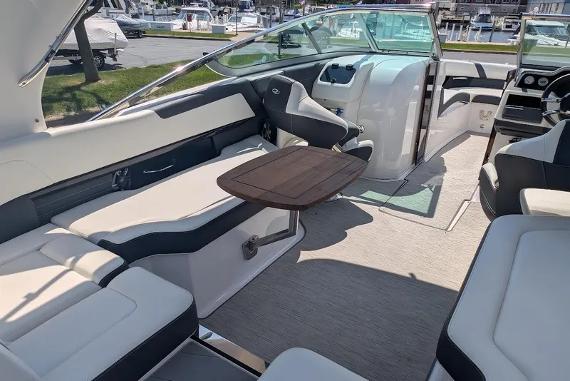 Slide: The Image of Interior of a 2017 Regal 2500 Bowrider boat with seating and a wooden table. - 39