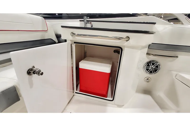 Slide: The Image of 2018 Formula 270 Sun Sport boat interior with open cabinet and red cooler. - 15