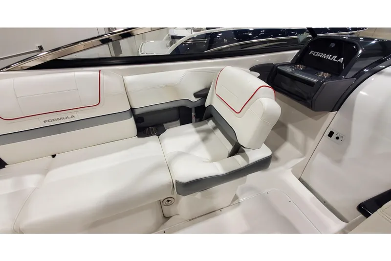 Slide: The Image of 2018 Formula 270 Sun Sport boat interior with white seating and red accents. - 18