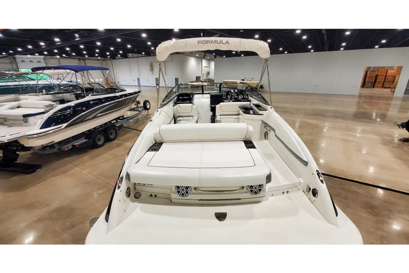Slide: The Image of 2018 Formula 270 Sun Sport boat displayed indoors, showcasing sleek design and spacious seating. - 5