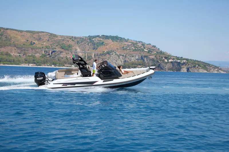 Slide: The Image of 2025 Ranieri CAYMAN 35.0 EXECUTIVE cruising on blue water near a scenic coastline. - 3