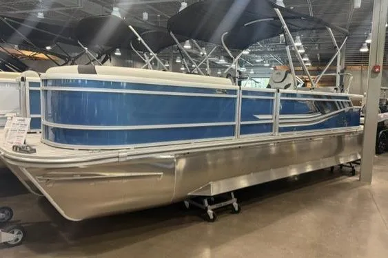 The Image of 2026 SunCatcher Select 322SL pontoon boat displayed indoors, featuring a sleek blue design. - 1