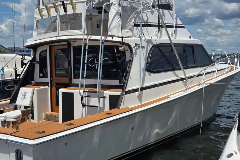 Slide: The Image of 1990 Egg Harbor Golden Egg 42 yacht docked, featuring sleek design and spacious deck. - 1