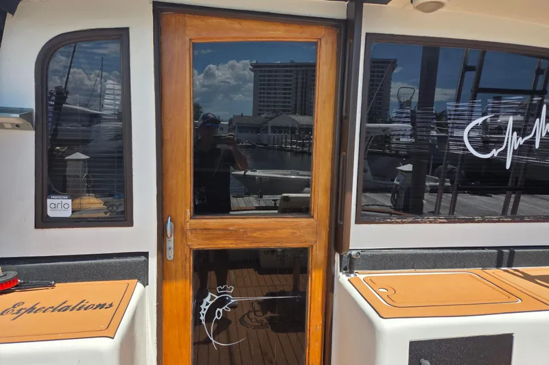 Slide: The Image of 1990 Egg Harbor Golden Egg 42 yacht with wooden door and marina reflection. - 12