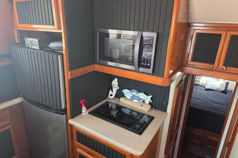 Slide: The Image of Kitchen area of a 1990 Egg Harbor Golden Egg 42 yacht with modern appliances. - 14