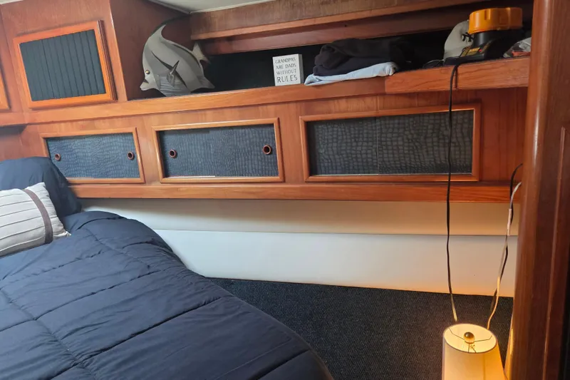Slide: The Image of Cozy cabin interior of 1990 Egg Harbor Golden Egg 42 yacht with wooden storage and bedding. - 18
