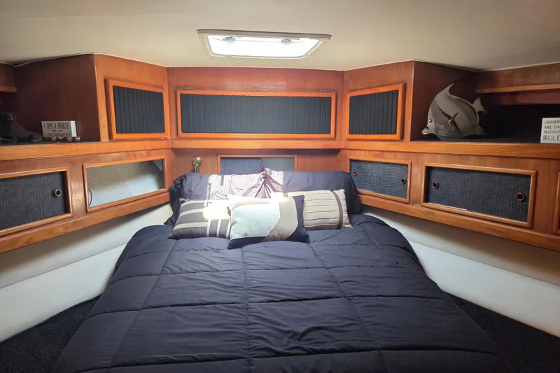 Slide: The Image of Cozy cabin interior of 1990 Egg Harbor Golden Egg 42 yacht with wood paneling and bedding. - 20