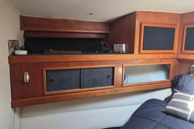Slide: The Image of Interior of 1990 Egg Harbor Golden Egg 42 yacht with wooden cabinetry and cozy bedding. - 21