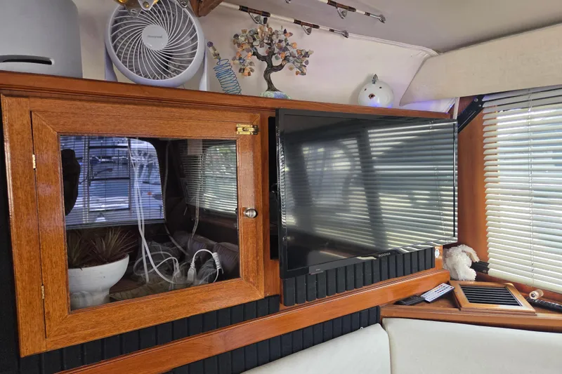 Slide: The Image of Interior of 1990 Egg Harbor Golden Egg 42 yacht with TV and wooden cabinet. - 24