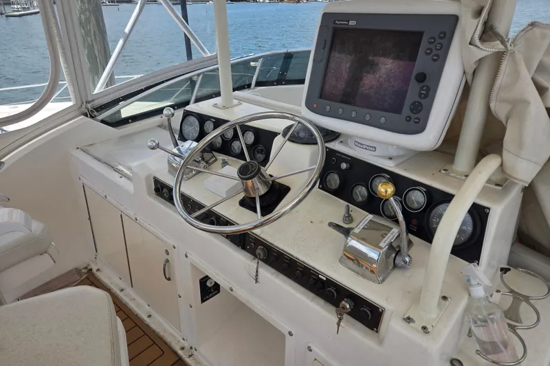 Slide: The Image of Cockpit of 1990 Egg Harbor Golden Egg 42 with steering wheel and navigation equipment. - 30